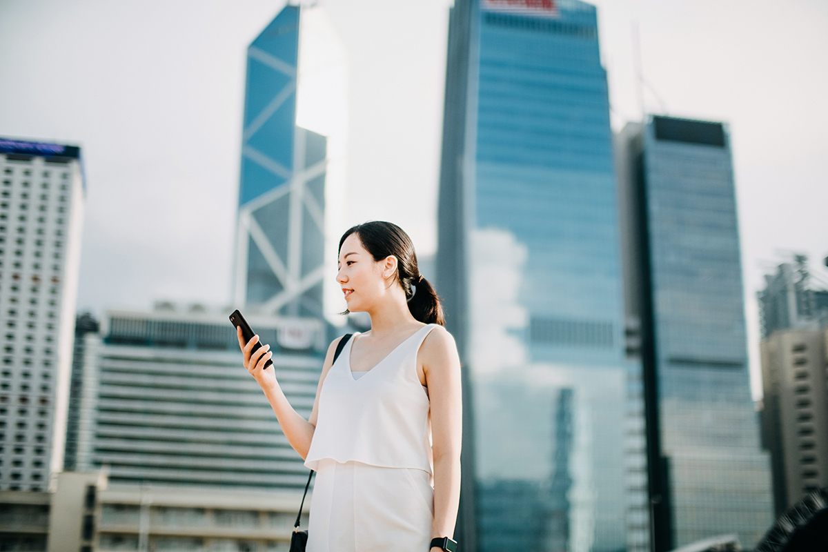 Girl using smartphone in Hong Kong